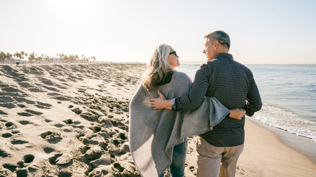 Blog Covers – 2025-04-01T131357.045 Senior couple walking down the beach at sunset