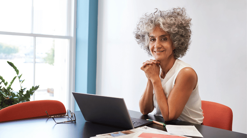Blog Covers – 2024-06-21T072347.387 (1) Business woman sitting at desk with computer open