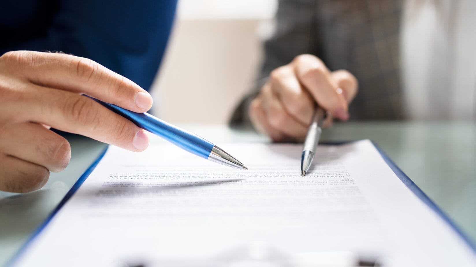 Blog Covers – 2024-08-06T075320.563 (1) 2 people reviewing a contract with a pen