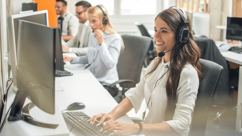 Call center with several individuals wearing headsets