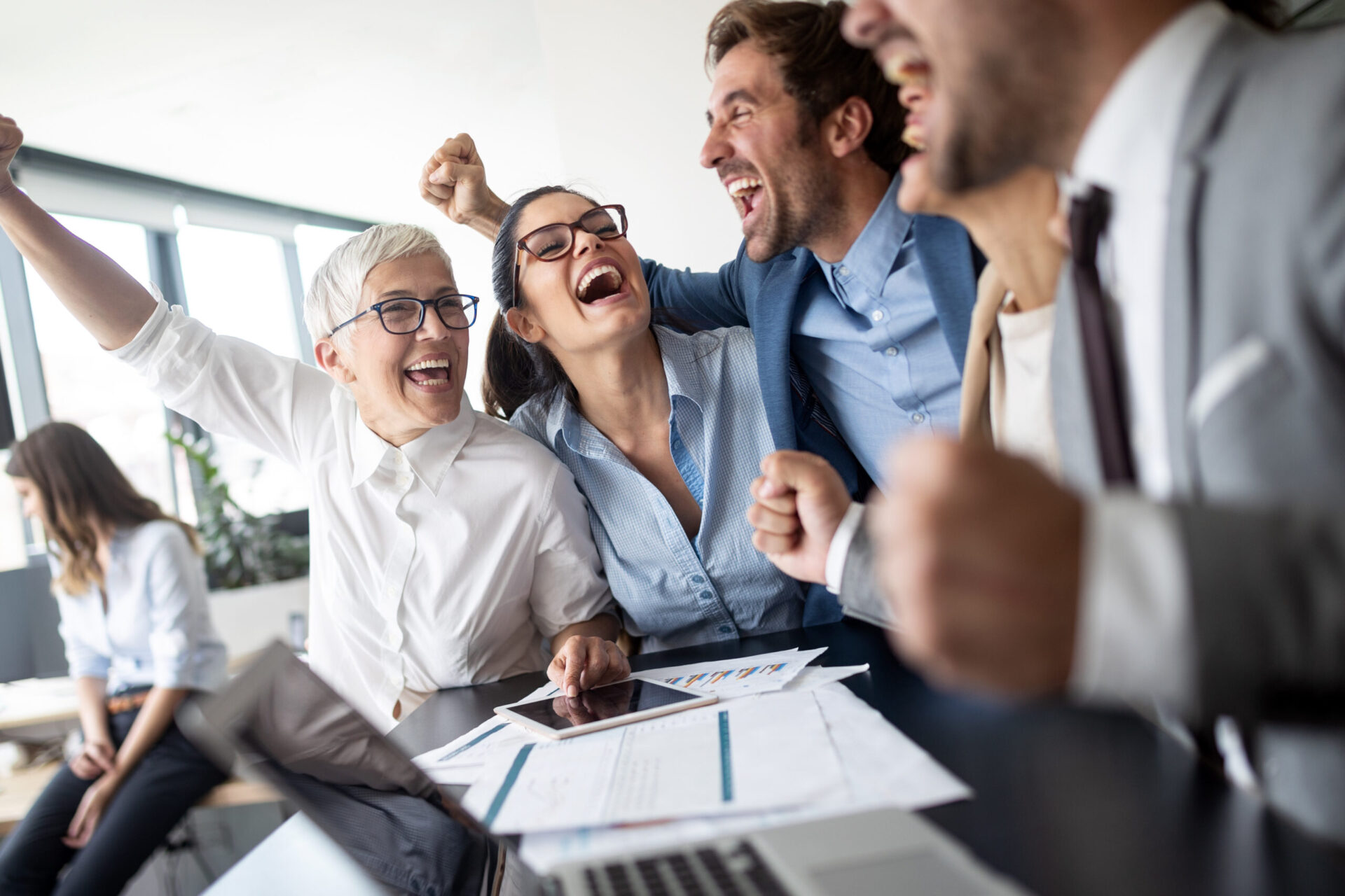 Business team celebrating a good job in the modern office