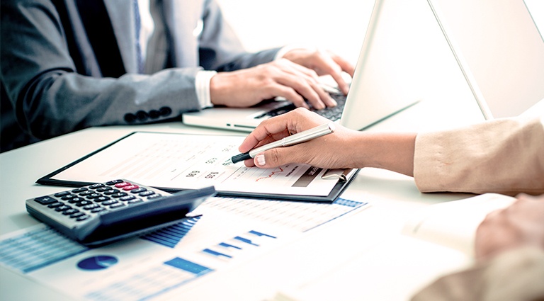 Buying-a-Franchise-Step-1 Business partners reviewing sales data
