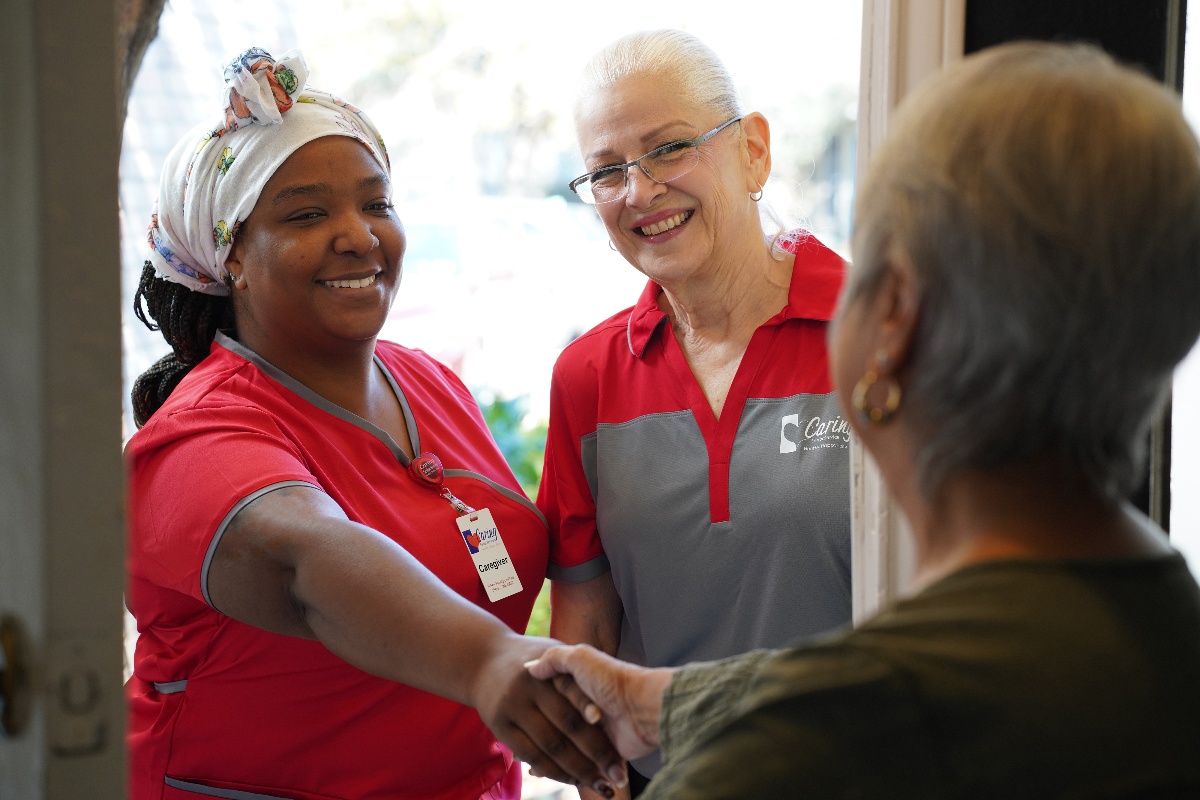 Caregiver20Shaking20Hands20at20Client20Door-1 Caregiver shaking hands with an elderly client