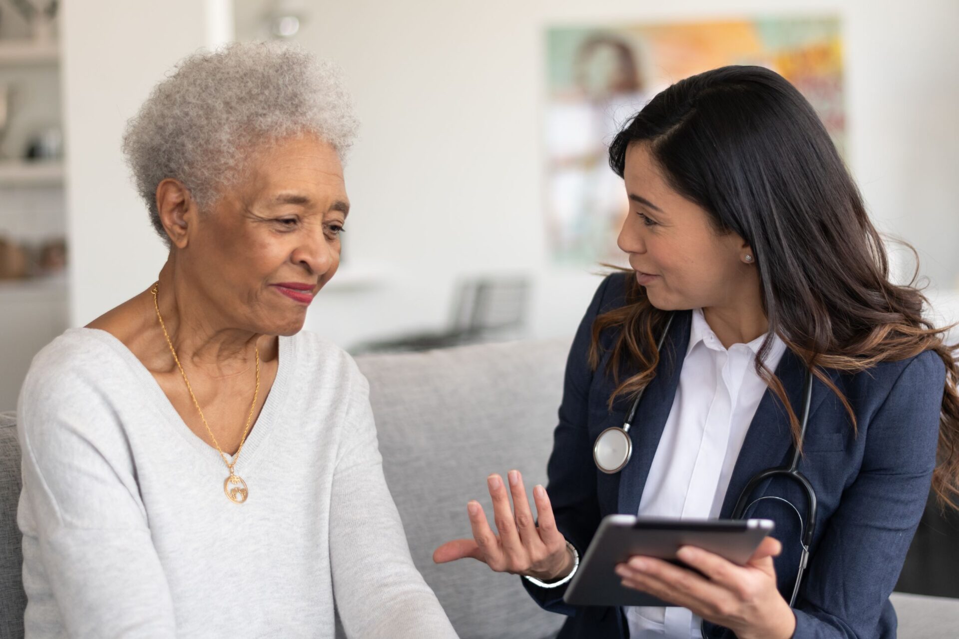 Doctor talking to a senior patient in their home