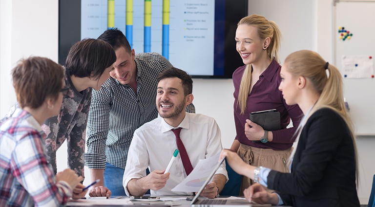 How-Economic-Cycles-Affect-Business-Owners-vs-Employees Group of young entrepreneurs reviewing business data