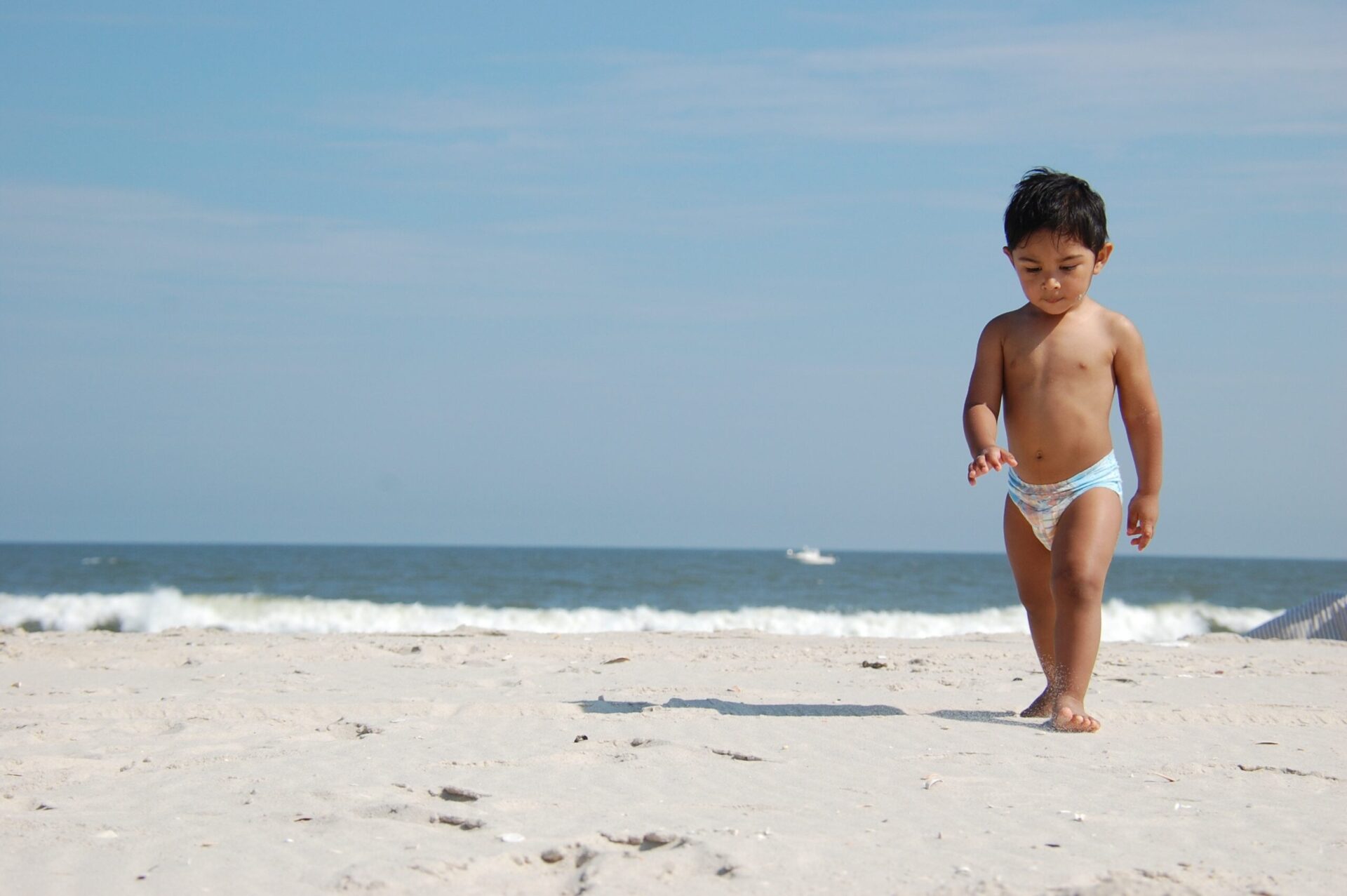 andre-mohamed-532287-unsplash-1 Toddler in a diaper walking along the beach