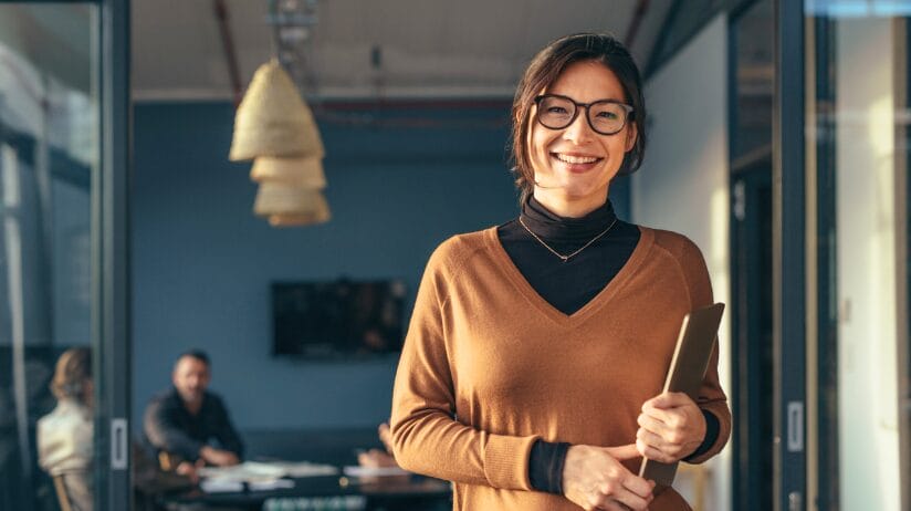 Blog Covers – 2024-09-03T100559.531 Smiling female entrepreneur in a small conference room