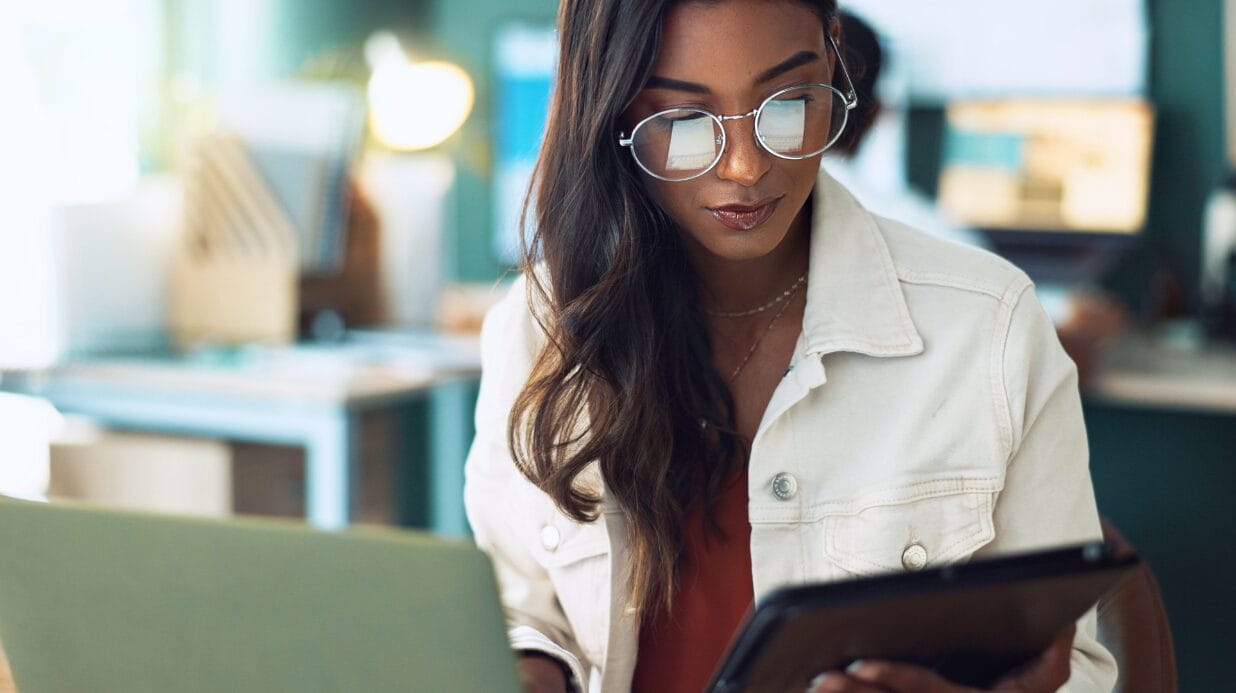 Blog Covers (45) Black female researching a business opportunity on a tablet and laptop