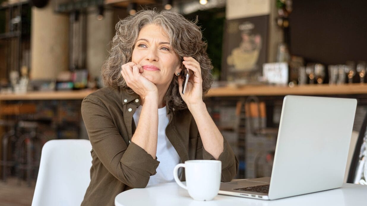 Blog Covers (51) Happy female entrepreneur taking a call while working at a cafe