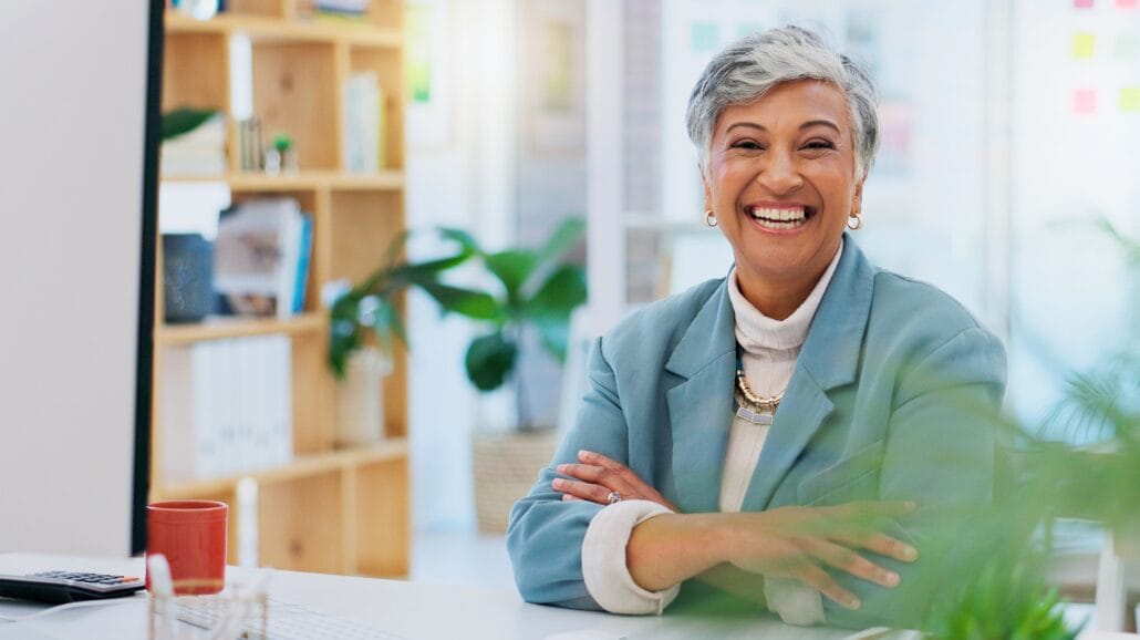 Blog Covers (64) Confident older businesswoman smiling while in front of a computer